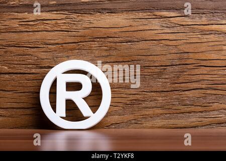 Registered Trademark Sign In Front Of Wooden Wall Stock Photo