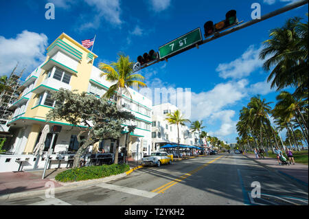 MIAMI - JANUARY 12, 2018: Brightly colored Art Deco buildings stand above an empty Ocean Drive on a quiet morning in South Beach. Stock Photo