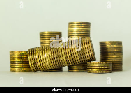 Stacks of copper coins on a white background. One stack lying on its side. A good image for a site about finance, money, collection, relationships. Stock Photo