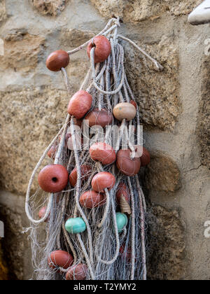 Image of colorful old and used fisher nets hanging on the wall Stock Photo