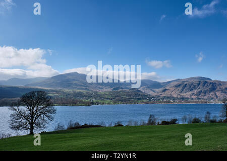 The Old Man of Coniston, Wetherlam, and Coniston village seen from Brantwood on the shores of Coniston Water, Lake District, Cumbria Stock Photo