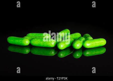 Lot of whole green sweet licorice comfit isolated on black glass Stock Photo