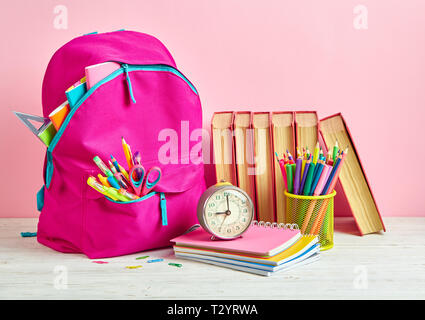 Bright composition from a school stationery on a pink background. School and office supplies frame Stock Photo