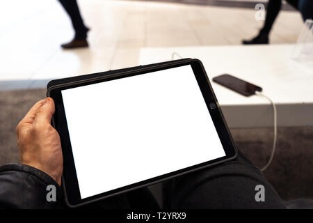 Real life use of tablet with free copy space for your ad and text - Mock up billboard and empty screen - Shopping centre Stock Photo