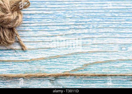 Linen twine on a wooden blue background Stock Photo