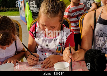 Tyumen, Russia - August 26, 2016: Open Day of Sberbank for children. Beauty salon site. The girl paints nails pattern Stock Photo