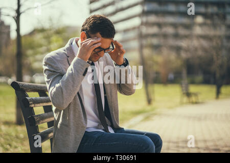Young businessman is having headache. Stock Photo