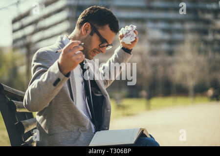 Young businessman is angry and overworked. Stock Photo