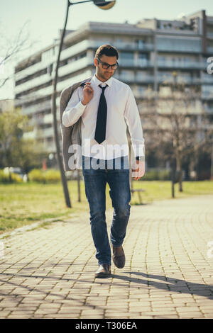 Young tired businessman is going home from work. Stock Photo