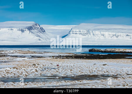 Dramatic winter landscape along Ísafjarðardjúp fjord near Ísafjörður in the Westfjords region, Iceland Stock Photo