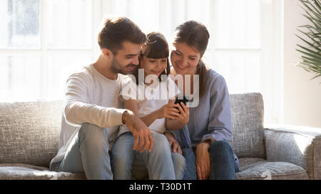 Little girl showing to parents favourite game play online Stock Photo
