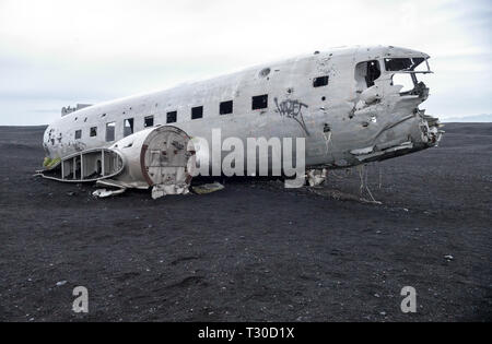 Wreckage of crashed airplane Dakota United States Navy Douglas Super DC-3 on the coast of iceland black sand beach. Solheimasandur, Iceland Stock Photo