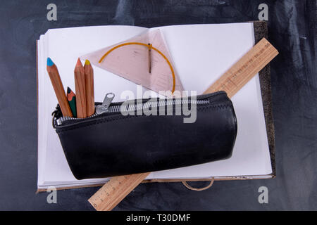 pencil case and ruler on a notebook with blank pages Stock Photo