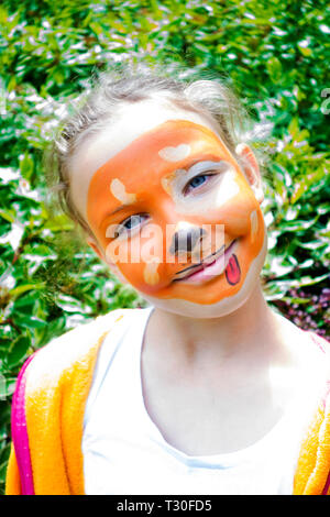 Young girl smiling with her face painted as a dog. Stock Photo
