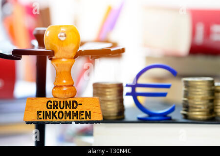 PHOTOMONTAGE, stamp with the label Basic income, FOTOMONTAGE, Stempel mit der Aufschrift Grundeinkommen Stock Photo