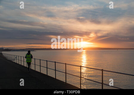 Newlyn, Cornwall, UK. 5th Apr, 2019. UK Weather. A cold but calm and colourful start to the morning at Newlyn looking out to Mounts Bay. Credit: Simon Maycock/Alamy Live News Stock Photo