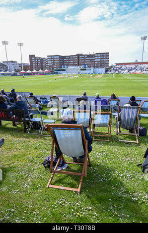 Hove Sussex, UK. 05th Apr, 2019. Spectators watch Sussex v Leicestershire in the Specasavers County Championship Division Two match at the 1st Central County Ground in Hove on a sunny but cool first morning of the season Credit: Simon Dack/Alamy Live News Stock Photo