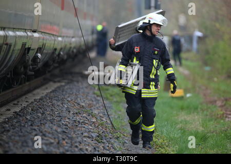 05 April 2019, North Rhine-Westphalia, Düsseldorf: An ICE of the Deutsche Bahn stands near the main station after the overhead line has been torn down. The firefighters wear bridge parts to connect the ICE with the replacement train. Photo: David Young/dpa Stock Photo