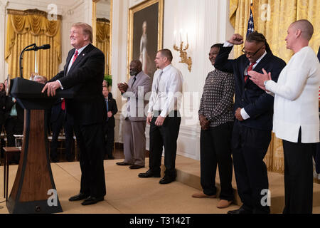 President Donald J. Trump congratulates former inmates who have benefited from the passage of the FIRST STEP Act at the 2019 Prison Reform Summit Monday, April 1, 2019, in the East Room of the White House  People:  President Donald Trump Stock Photo