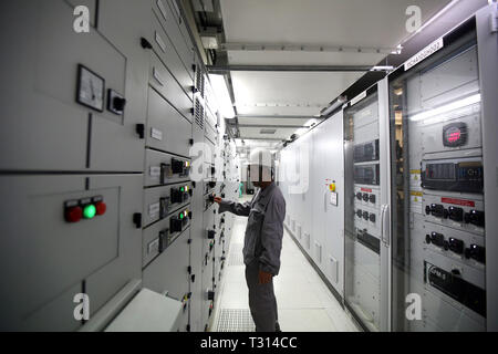 Thaton, Myanmar. 5th Apr, 2019. A technician from China Energy Engineering Corporation inspects the combined cycle gas turbine power plant in Thaton Township, Mon State, Myanmar, April 5, 2019. A combined cycle gas turbine power plant with the capacity of 118.9 megawatts (MW) opened in Myanmar's Mon state on Friday. With loans from the World Bank, the power plant project was implemented by the tender-winning China Energy Engineering Corporation. Credit: U Aung/Xinhua/Alamy Live News Stock Photo