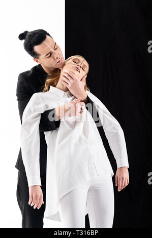 Extraordinary photo. Young promising models wearing black and white clothing posing for extraordinary photo session Stock Photo