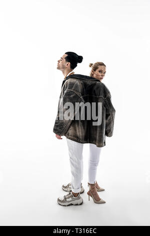 Promoting clothes. Professional young creative models showing nice poses while promoting clothes Stock Photo