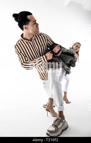 Promoting new brand. Two professional models wearing white trousers promoting new brand of clothes Stock Photo