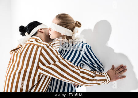 Nice poses. Blonde-haired model showing nice poses with her colleague while wearing blindfolds Stock Photo