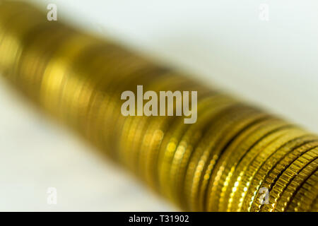 Macro photo of a long stack of coins. Stack lying on their side. A good image for a site about finance, money, collection, relationships. Stock Photo