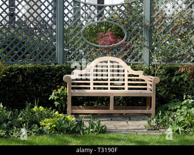 Ornate wooden bench in a garden Stock Photo