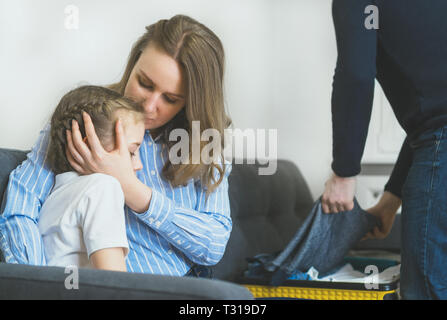 Quarrel in the family. Father is packing his clothes and leaving. Stock Photo