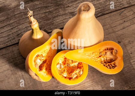 Fresh butternut squash on rustic wooden table. Cucurbita moschata Stock Photo