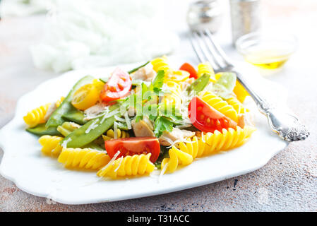 pasta with grilled chicken meat, vegetables and cheese Stock Photo