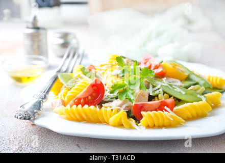 pasta with grilled chicken meat, vegetables and cheese Stock Photo