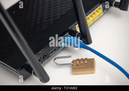 Network and data protection concept with padlock. Internet router or switch with cable plugged in. Stock Photo