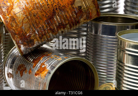 Stack of rusty empty tin cans close-up Stock Photo