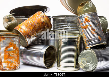 Stack of rusty empty tin cans on white background Stock Photo