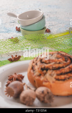 Vertical photo of three small bowls or cups. Cups have simple holder. Each cup has different color - white, blue and green. Spices are spilled around  Stock Photo