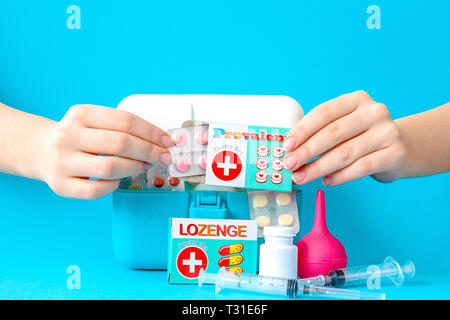 Flat lay composition with first aid kit on blue background. Stock Photo