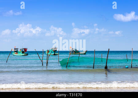 Traditional Vietnamese fishing boats anchored off shore at Bai Dai Tay beach on Phu Quoc Island in the Gulf of Thailand, Vietnam, Asia Stock Photo