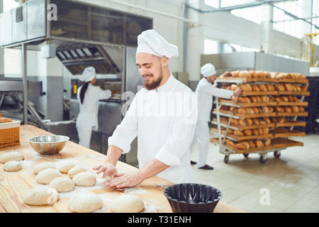 Bearded man baker at the bakery. Stock Photo