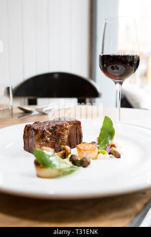 Beef brisket with mushrooms, sage and a glass of red wine Stock Photo