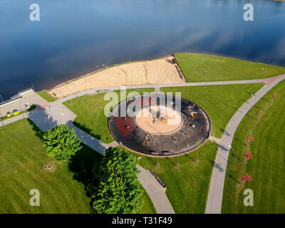 Modern new circle playground on lake coast in park, aerial view Stock Photo