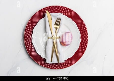 Table setting for Easter on marble background. Concept of Easter food. Table top, flat lay, concept of holiday decor Stock Photo