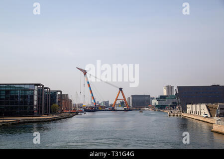 Copenhagen, Denmark - April 4, 2019: The huge Floating Crane Hebo Lift 9 installing parts for a new cycling bridge over the harbour. Stock Photo