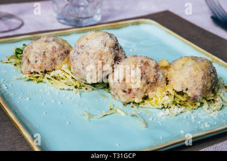 Picture of a plate of Canederli, a typical italian pasta made with bread, Cortina D'Ampezzo, Italy Stock Photo