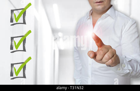 Checklist touchscreen concept is operated by man. Stock Photo