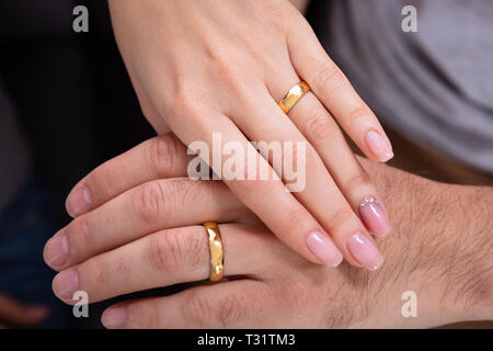 High Angle View Of A Couple's Hand Showing Their Wedding Rings Stock Photo