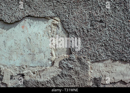 Old Grey Wall With Part Of Stucco And First Layer Wall Under It. Horizontal texture Stock Photo