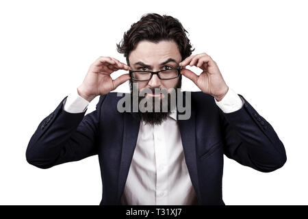 bearded business man isolated on white background, raised an eyebrow and seriously looks at the viewer Stock Photo